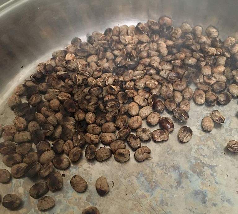 Coffee beans being pan-roasted